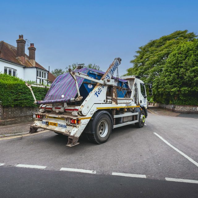 SCS Waste Skip Lorry Carrying An SCS Waste Skip